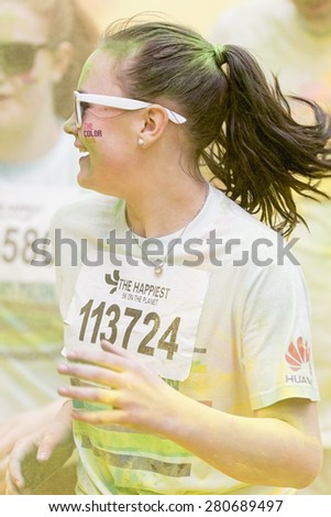 STOCKHOLM, SWEDEN - MAY 23: Happy girl running at Stockholm Color Run in Tantolunden or Tanto on May 23, 2015. People from all walks of life participated in the run.
