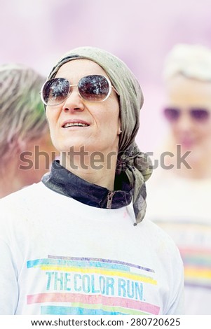 STOCKHOLM, SWEDEN - MAY 23: Woman looking up at Stockholm Color Run in Tantolunden or Tanto on May 23, 2015. People from all walks of life participated in the run.