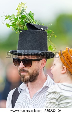 STOCKHOLM - JUNE 6: Traditional Hat parade with a man and child before the horse racing competition at Nationaldags Galoppen at Gardet. June 6, 2015 in Stockholm, Sweden.
