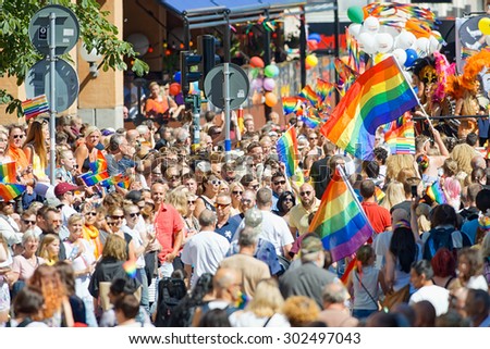 STOCKHOLM, SWEDEN - AUGUST 1, 2015: The crowded streets during the Pride parade in Stockholm. Approx 400.000 gathered at the streets.