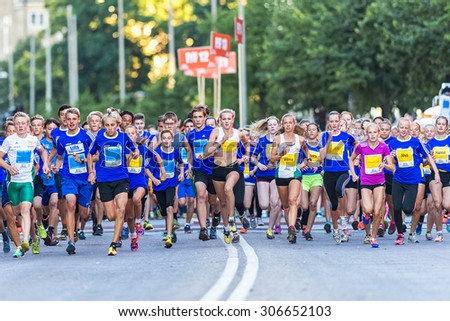 STOCKHOLM, SWEDEN - AUGUST 15, 2015: Runners just after the start at Lilla Midnattsloppet for aged 15. The track is 1775 meters and the runners are aged 8-15 years.