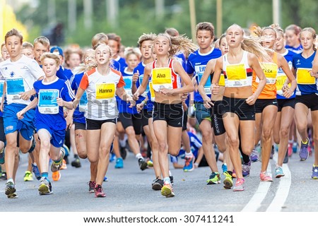 STOCKHOLM, SWEDEN - AUGUST 15, 2015: Runners just after the start at Lilla Midnattsloppet for runners aged 13. The track is 1775 meters and the runners are aged 8-15 years.