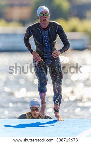 STOCKHOLM - AUG 22, 2015: Leading triathlete woman after the first stretch at the swimming in the Womens ITU World Triathlon series event.