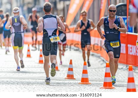 STOCKHOLM - AUG 23, 2015: Triathletes running at the cobblestones in the old town at the ITU World Triathlon event in Stockholm.