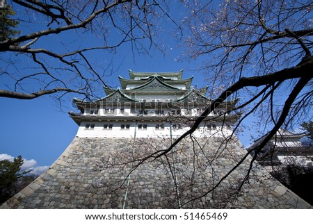 Nagoya Castle in Japan with trees foreground