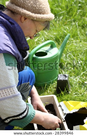 A woman potting soil in spring.