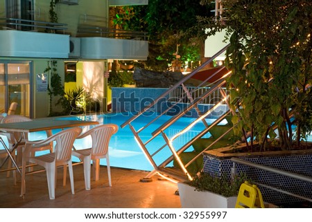 Part of blue swimming pool in the evening. Natural lighting without processing