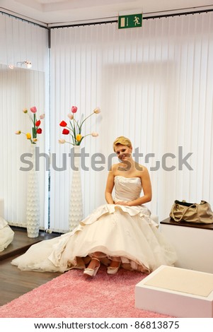 Pretty bride  in a wedding gown in the bridal shop.