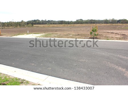 Vacant land in a new real estate subdivision in australia with new road in foreground