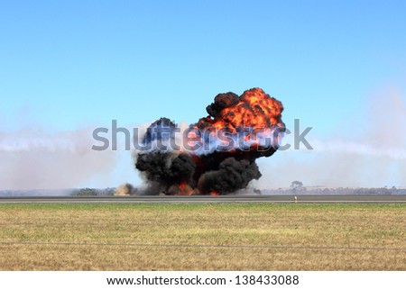 Large explosion with fire ball and smoke at a public display