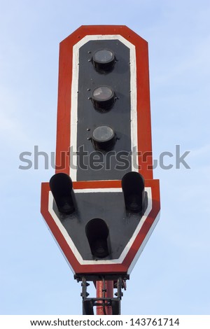 A rail road signal with one light on