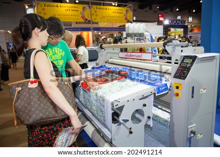 BANGKOK - JUNE 28 :Unidentified people interesting with Digital textile printer at Garment  Manufacturers Sourcing 2014 on June 28,2014 in ,Bangkok, Thailand.