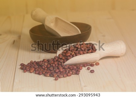 Fresh coffee bean and wood spoon on soft light ,warm tone