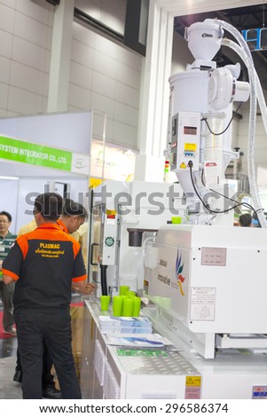 BANGKOK ,THAILAND - JULY 11: Unidentified people interesting a PET perform injection machine at InterPlas Thailand 2015 , on JULY 11, 2015 in Bangkok, Thailand.