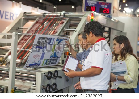 BANGKOK - AUGUST 29 :Unidentified people interesting with  \
printing on paper box at Pack Print and T-PLAS THAILAND on Aug \
29,2015 in BITEC ,Bangkok, Thailand.