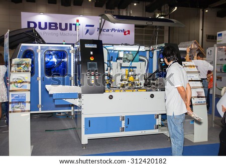BANGKOK - AUGUST 29 :Unidentified people interesting with \
industrial printing machine at Pack Print and T-PLAS THAILAND on \
Aug 29,2015 in BITEC ,Bangkok, Thailand.