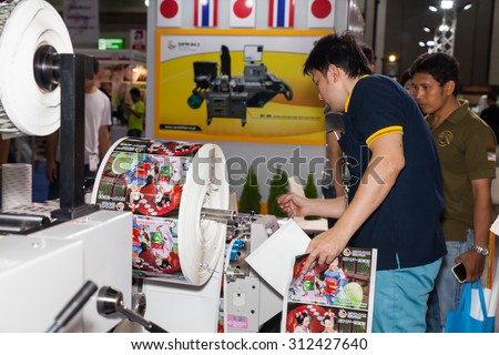BANGKOK - AUGUST 1 :Unidentified people checking with roll of 
print paper machine at Pack Print and T-PLAS THAILAND on Aug 
29,2015 in BITEC ,Bangkok, Thailand.