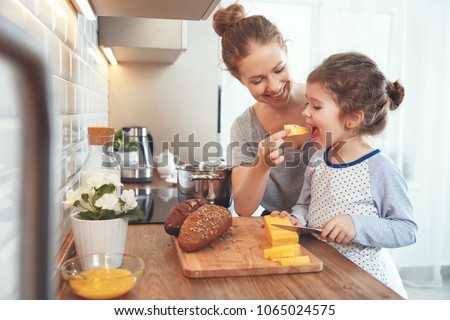 Image, Stock Photo Smiling woman cutting cheese for salad in kitchen