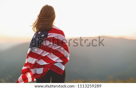 young happy woman with flag of united states enjoying the sunset on nature Stockfoto © 