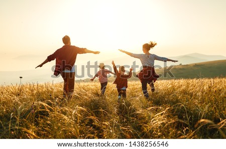 Photo of Happy family: mother, father, children son and  daughter on nature  on sunset
