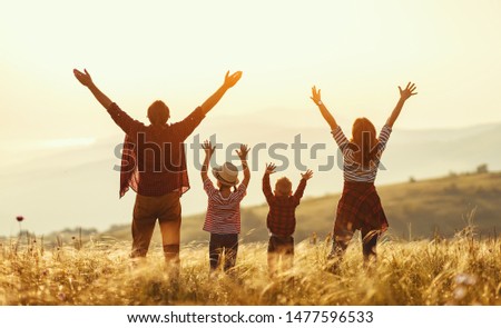 Happy family: mother, father, children son and  daughter on nature  on sunset 商業照片 © 