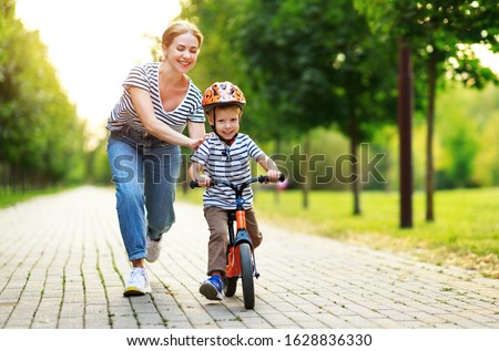 Similar – Foto Bild Mutter und Sohn reiten entlang des Parkwegs