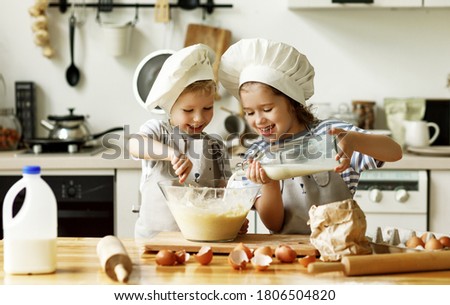 Similar – Image, Stock Photo Cheerful siblings mixing dough together in kitchen