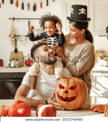 happy multiethnic family mother, father and little son have fun and celebrate Halloween at home