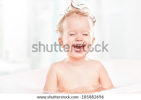 happy funny baby  laughing and bathed in the bath