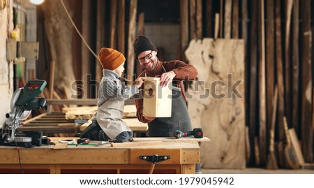 Similar – Image, Stock Photo Male woodworker teaching son in workshop