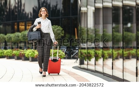 Similar – Image, Stock Photo Stylish businesswoman walking along street in city