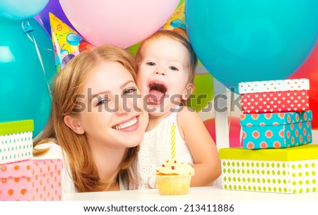 happy children\'s birthday. mother, baby daughter, balloons, cake, gifts