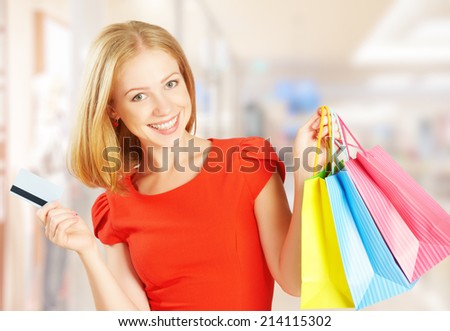 happy beautiful woman on shopping with bags and credit cards, christmas sales, discounts