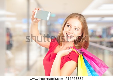 Selfie, a successful shopping happy woman with shopping bags
