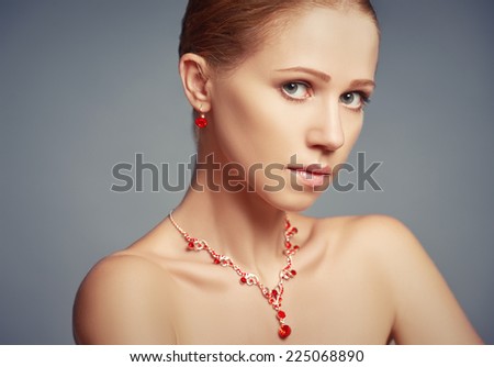 beauty girl with red jewelry necklace and earrings with rubies