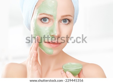 beautiful girl in the bathroom and mask for facial skin care