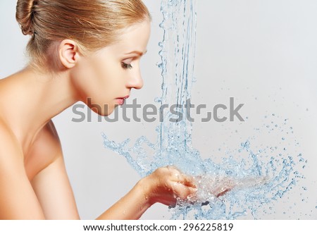 Beauty woman skin care, washing with splashes and drops of water