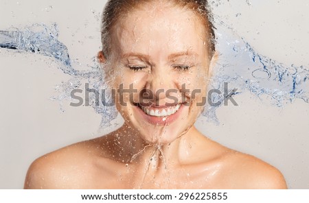 Happy beauty woman skin care, washing with splashes and drops of water
