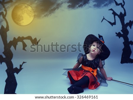 Halloween. little witch dreams fly to the moon in the night sky