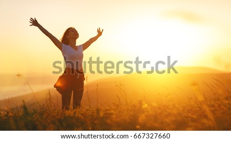 Photo of Happy woman   on the sunset in nature in summer with open hands