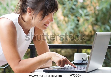 brunette girl searching something on laptop