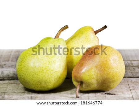 three pears on wooden table