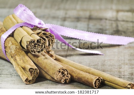 cinnamon spice with ribbon on wooden table