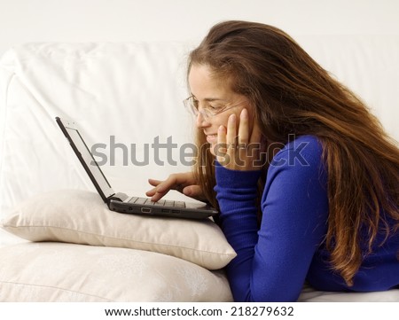 smiling girl with glasses searching something in internet