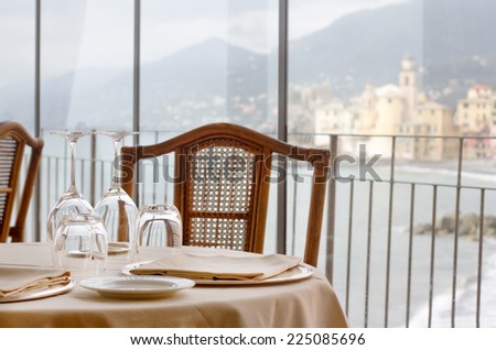elegant restaurant table against Camogli background
