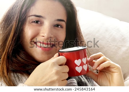 smiling girl with Valentine hearts decorated mug