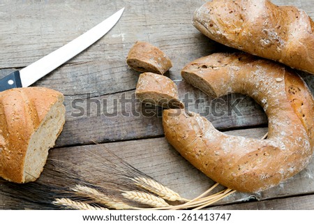 doughnut rye bread and cereal french bread over wood with knife