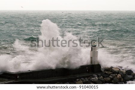 wave crashing on lighthouse