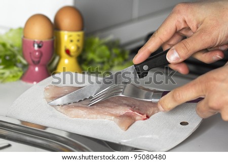 raw meat cut action on a kitchen background