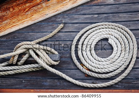coiled rope on wooden deck of yacht
